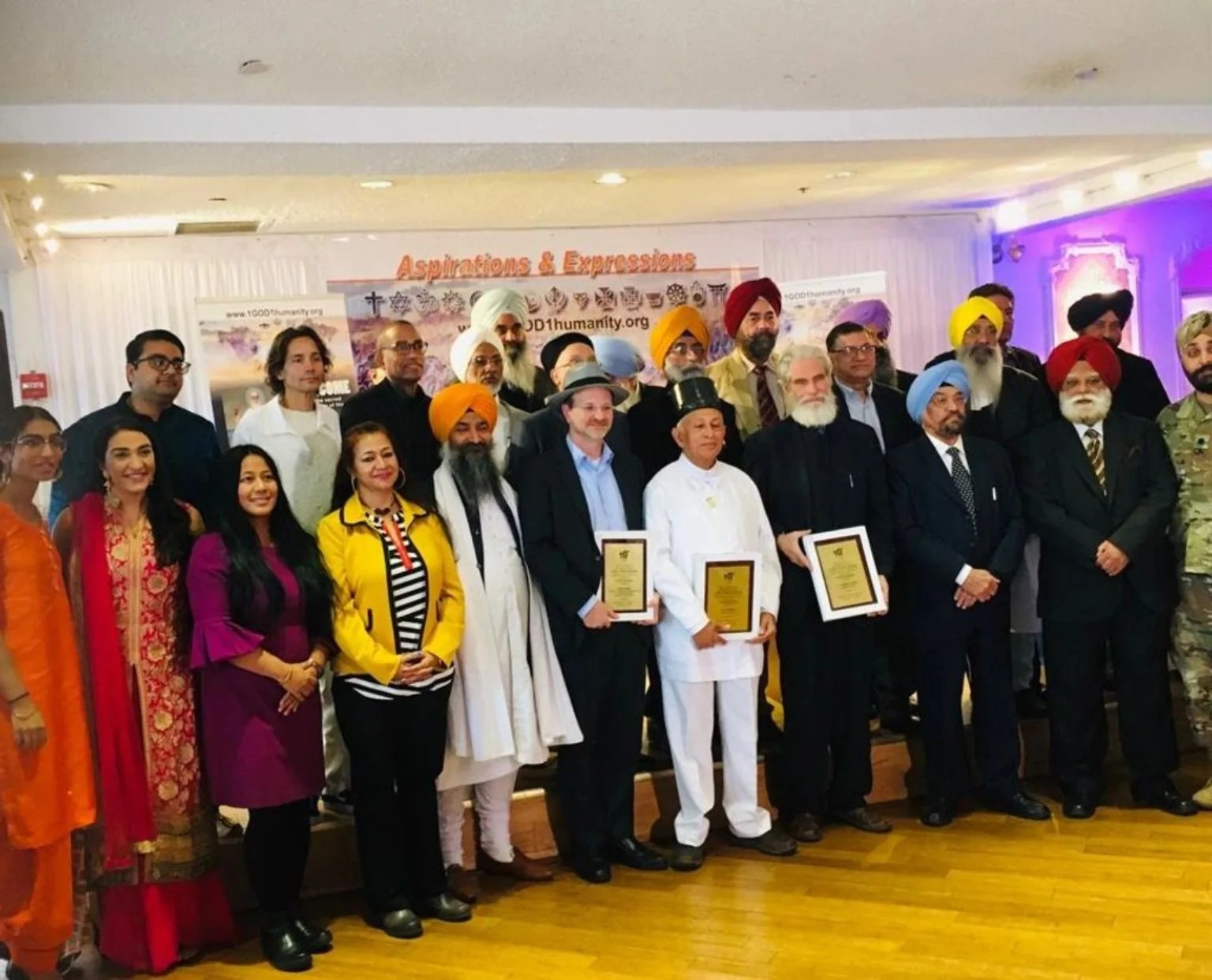 A large interfaith group gathered at a public recognition event in New York.
